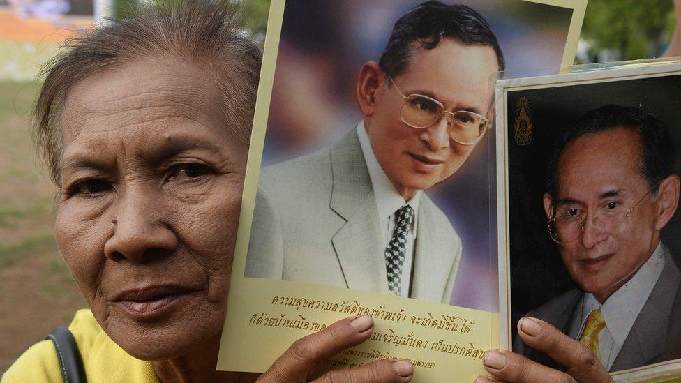 Man holding picture of King Bhumibol Adulyadej