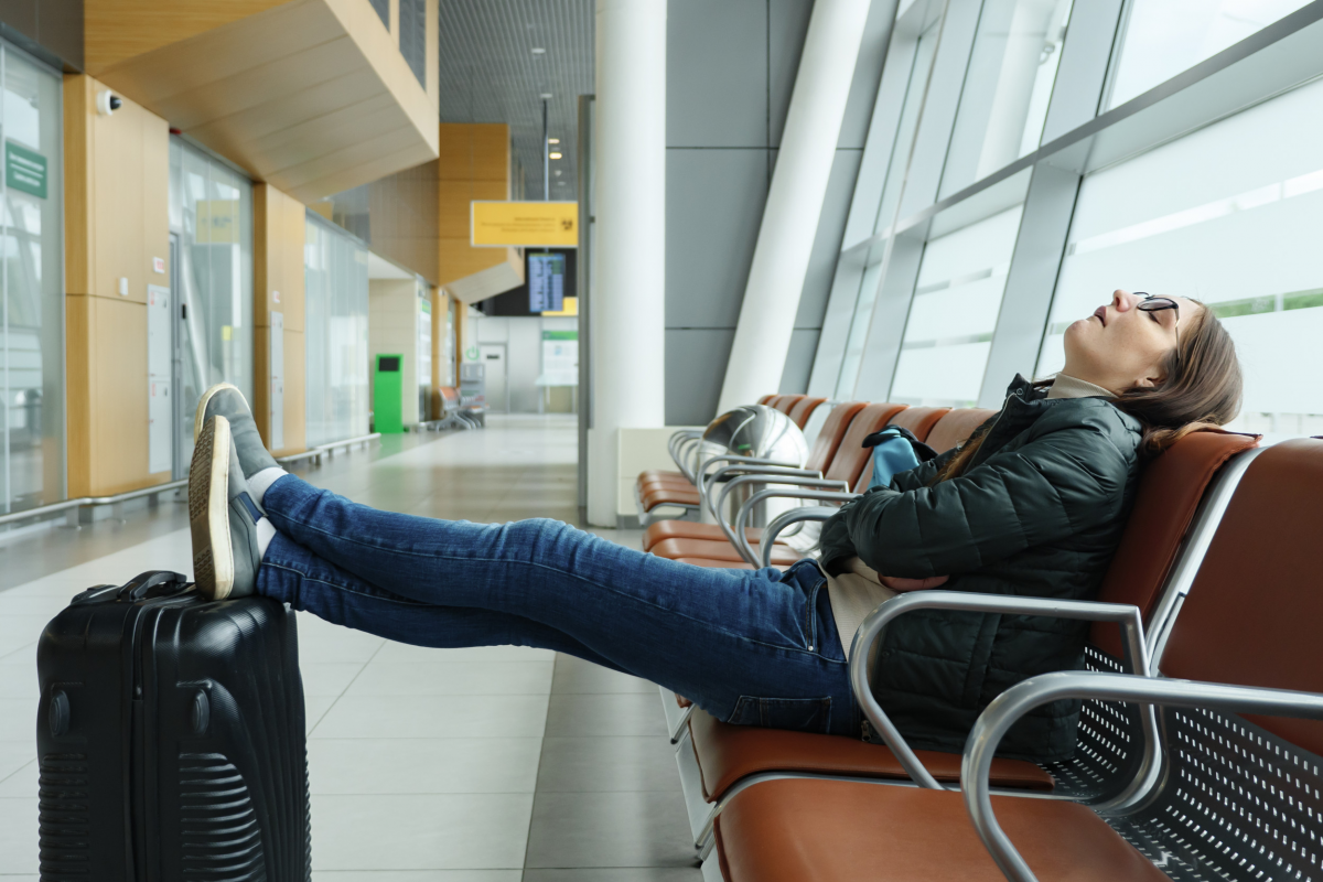a girl sleeping on chair on airport